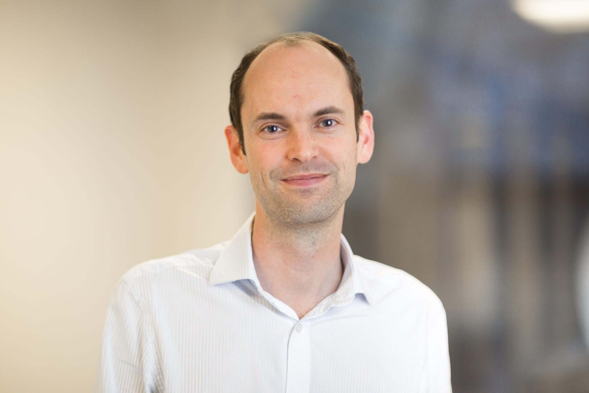 Nick Bostrom, pensive, standing in front of whiteboard with equations