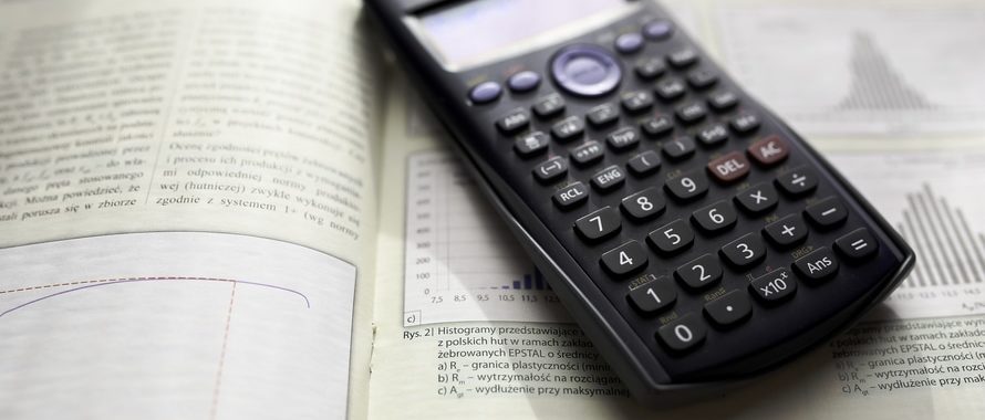 scientific calculator on open book on statistics