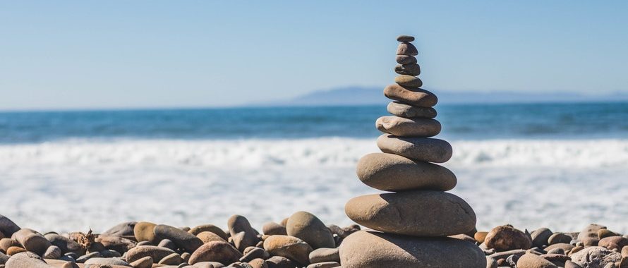 rocks balancing on top of each other at ocean